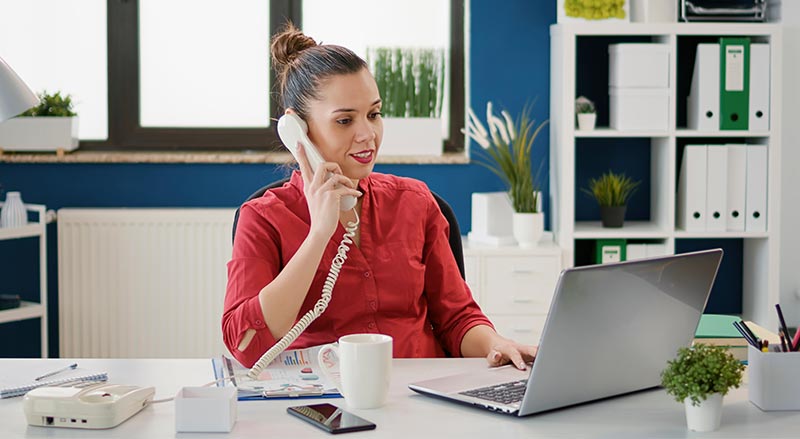 Woman talking on office phone