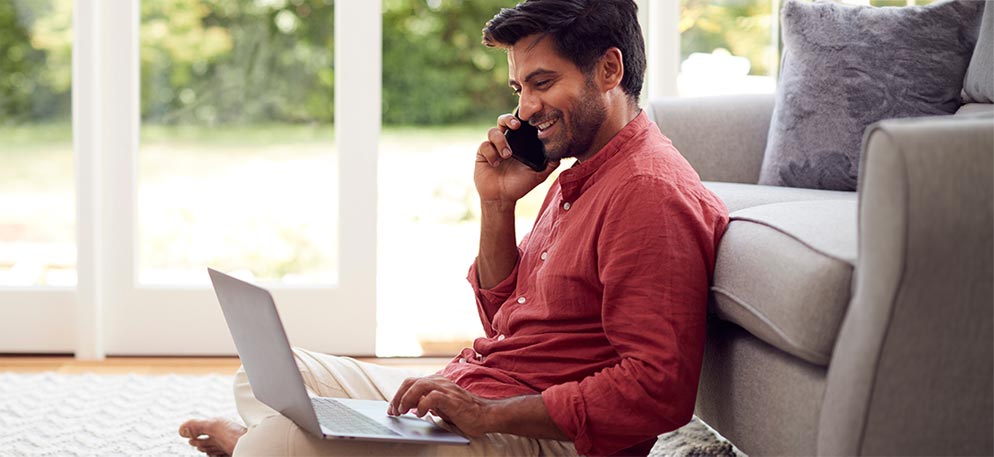 man using laptop and cell phone