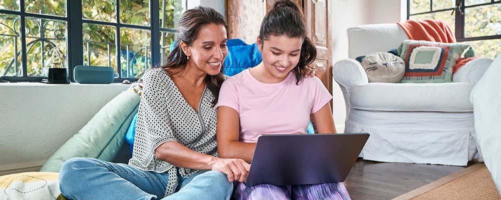 Mother and teen using laptop